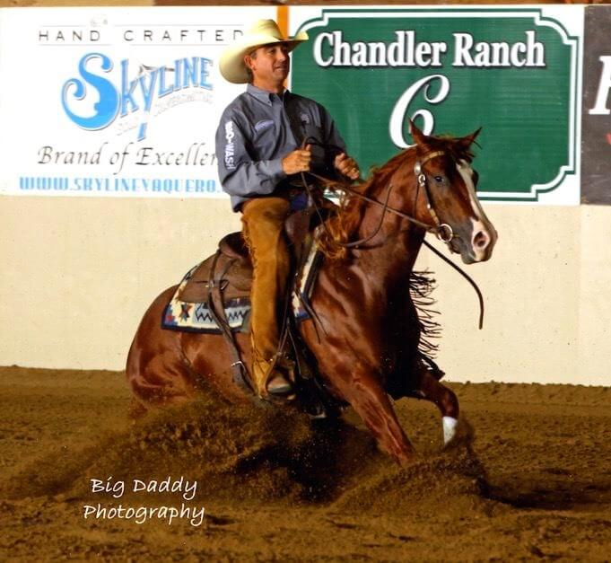 Jake Gorrell riding a chestnut horse in an arena