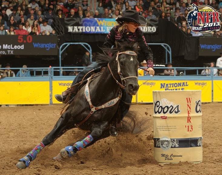 Michele McLeod on a horse cornering around a barrel