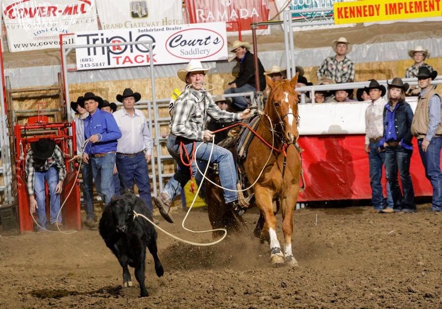 Treg Schaack dismounting a horse at a competition