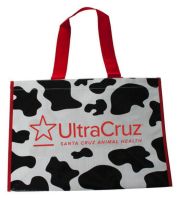 The UltraCruz&reg; Cow Print Bag features a bold black and white cow print design with a red logo and handles, providing a sty